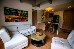 a living room with a couch and a table at Home away from home - By Adri in Envigado