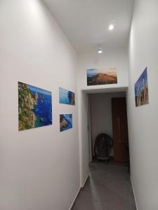 a hallway with several pictures on the wall at B&b Ai Vecchi Mulini in Gragnano