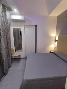 a bedroom with a bed and a chair in a room at B&b Ai Vecchi Mulini in Gragnano