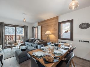 a living room with a table and a couch at L'O Rouge - Apt A02 - BO Immobilier- remises sur les forfaits de skis Châtel ou Portes du soleil in Châtel
