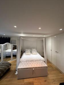 a bedroom with a bed with a canopy at Ensuite in London