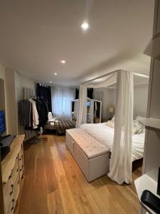 a bedroom with a bed with a canopy at Ensuite in London