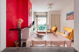 un soggiorno con tavolo e parete rossa di Casa di Titina a Otranto a Otranto