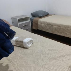 una camera con due letti, un comodino e un letto sidx sidx. di LA MAXIMIANa a Libertador General San Martín