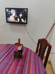 una tv appesa al muro con un tavolo e un proiettore di LA MAXIMIANa a Libertador General San Martín