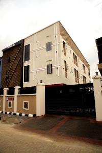 a large white building with a tunnel in front of it at Kaashmeen Hotel & Suite in Lagos