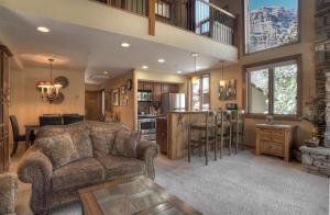 a living room with a couch and a kitchen at Tamarron HighPoint - 599-600 in Durango