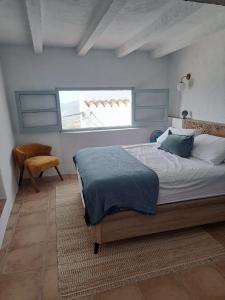 a bedroom with a large bed and a window at Casa Luna Miel in Frigiliana