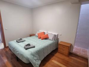 a bedroom with a bed with towels on it at Apto Vista Baía Machico in Machico
