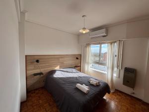a bedroom with a bed and a large window at Tigre Centro A - piscina y seguridad 24hs - Opcional cochera paga in Tigre +15 photos