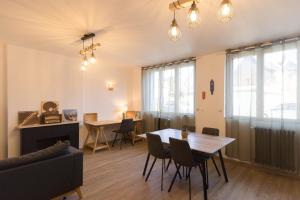 a living room with a table and a couch at Urban Nest Vitré in Vitré