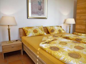 a bedroom with two beds with yellow pillows at Ferienwohnung Koch Thurgauer Weg in Reichenau