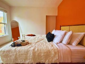 a bedroom with a bed with a table on it at Jungle House Luxury Stays - Columbus Downtown Short North in Columbus