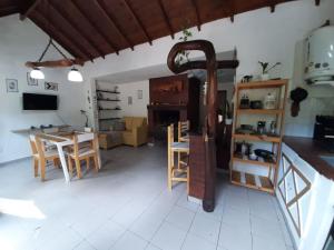a kitchen and living room with a table and chairs at Buenas Ondas in Mar Azul