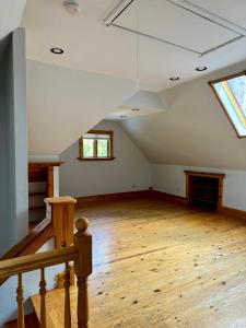 an attic room with wooden floors and a skylight at Jungle House Luxury Stays - Columbus Downtown Short North in Columbus