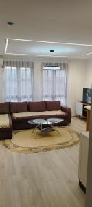 Una sala de estar con un sofá marrón y una mesa. en Masa, en Arandjelovac 17 fotos más