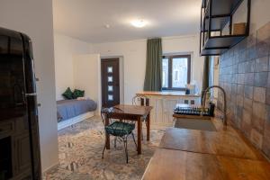 a kitchen and living room with a table and chairs at FIAMBI & b in Colugna