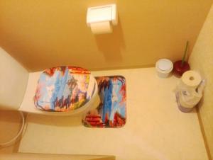 a bathroom with two plates and a toilet paper roll at ふるさと in Wada