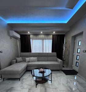 a living room with a couch and a table at Studio apartman Luna in Vinkovci