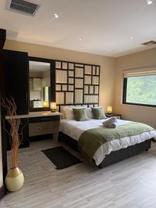 En eller flere senge i et værelse på 6 Baluwatu, Zimbali Coastal Estate