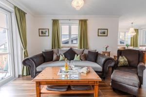 a living room with couches and a coffee table at Villa Eisl-Raudaschl in St. Wolfgang