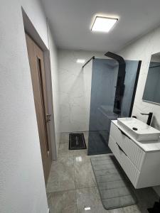 a bathroom with a sink and a shower at Sunny Hill Cab in Bulz +8 photos