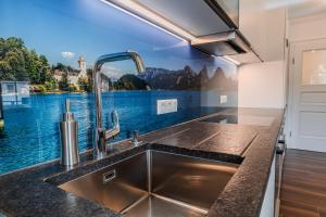 a kitchen with a sink and a view of a lake at Villa Eisl-Raudaschl in St. Wolfgang