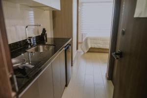 a kitchen with a sink and a counter top at Torre U kooliving in Manizales +22 photos