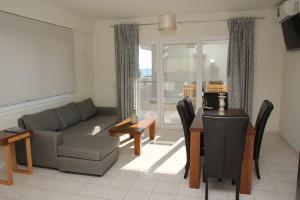 a living room with a couch and a table at Holiday Luxury Villas in Kalamaki