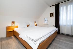 a bedroom with a large bed and a window at Pension zur Schleuse Kleinmachnow in Kleinmachnow