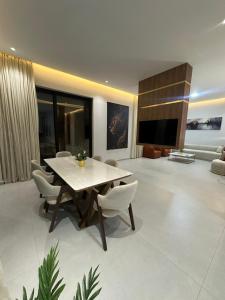a living room with a white table and chairs at Luxury Villa Marrakech in Marrakesh