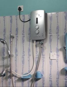 a soap dispenser on the wall of a bathroom at Himasha Guest in Mirissa