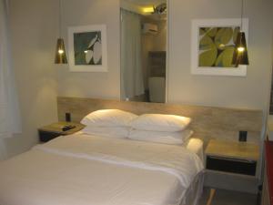 Ένα ή περισσότερα κρεβάτια σε δωμάτιο στο Condo Prudente 108