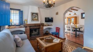 a living room with a couch and a fireplace at Villa Azul by Casitas Select in Acebuchal