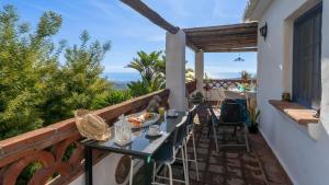 a balcony with a table with food on it at Villa Azul by Casitas Select in Acebuchal