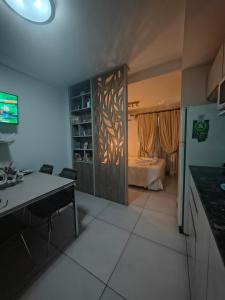 a kitchen with a desk and a room with a bed at Opalo Barrio Sur A Estrenar by Citrino Aparts in San Miguel de Tucumán +25 photos