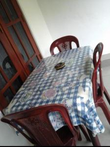 a table with a quilt on top of it at Himasha Guest in Mirissa