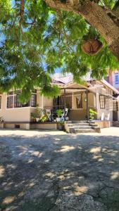 a house with a tree in front of it at Rococo by Concordia Hospitality in Shillong