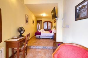 Ένα ή περισσότερα κρεβάτια σε δωμάτιο στο Hostal San Pedro