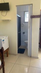 a bathroom with a shower and a toilet in it at Porto Pousada com café in Imbituba +13 photos