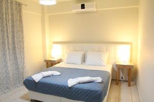 a bedroom with a bed with two towels on it at Holiday Luxury Villas in Kalamaki Heraklion +54 photos