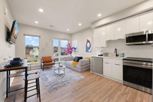 a kitchen and living room with white cabinets at Citizen Apartment Washington DC in Washington, D.C.