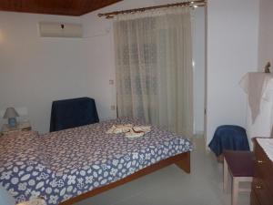 Postel nebo postele na pokoji v ubytování Villa Faidra