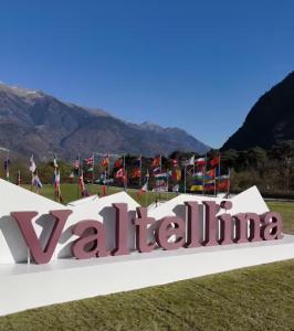 a sign for valhalla with flags in the background at Mary House in Sondrio