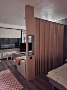 a bedroom with a large wooden partition with a tv on it at Apartment 55m2 in Kemijärvi 