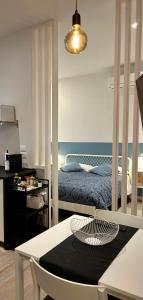 a bedroom with a bed and a table with a table at Suite Apartments - Corso51 in Rimini