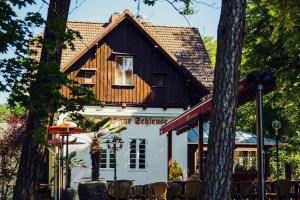 a man standing in front of a building at Pension zur Schleuse Kleinmachnow in Kleinmachnow