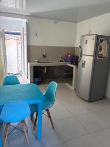 a kitchen with a blue table and a refrigerator at Apartaestudio Sara en Coveñas in Coveñitas
