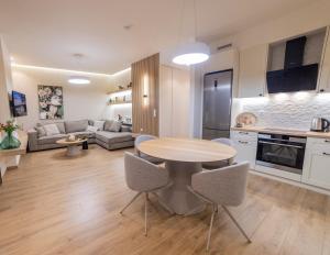 a kitchen and living room with a table and chairs at Andre House Trikala in Méga Kefalóvryson