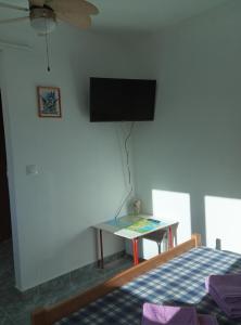 a bedroom with a bed and a tv on the wall at Villa Abelia in Medulin